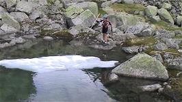 Tao uses a long stick to try to bring the iceberg to shore
